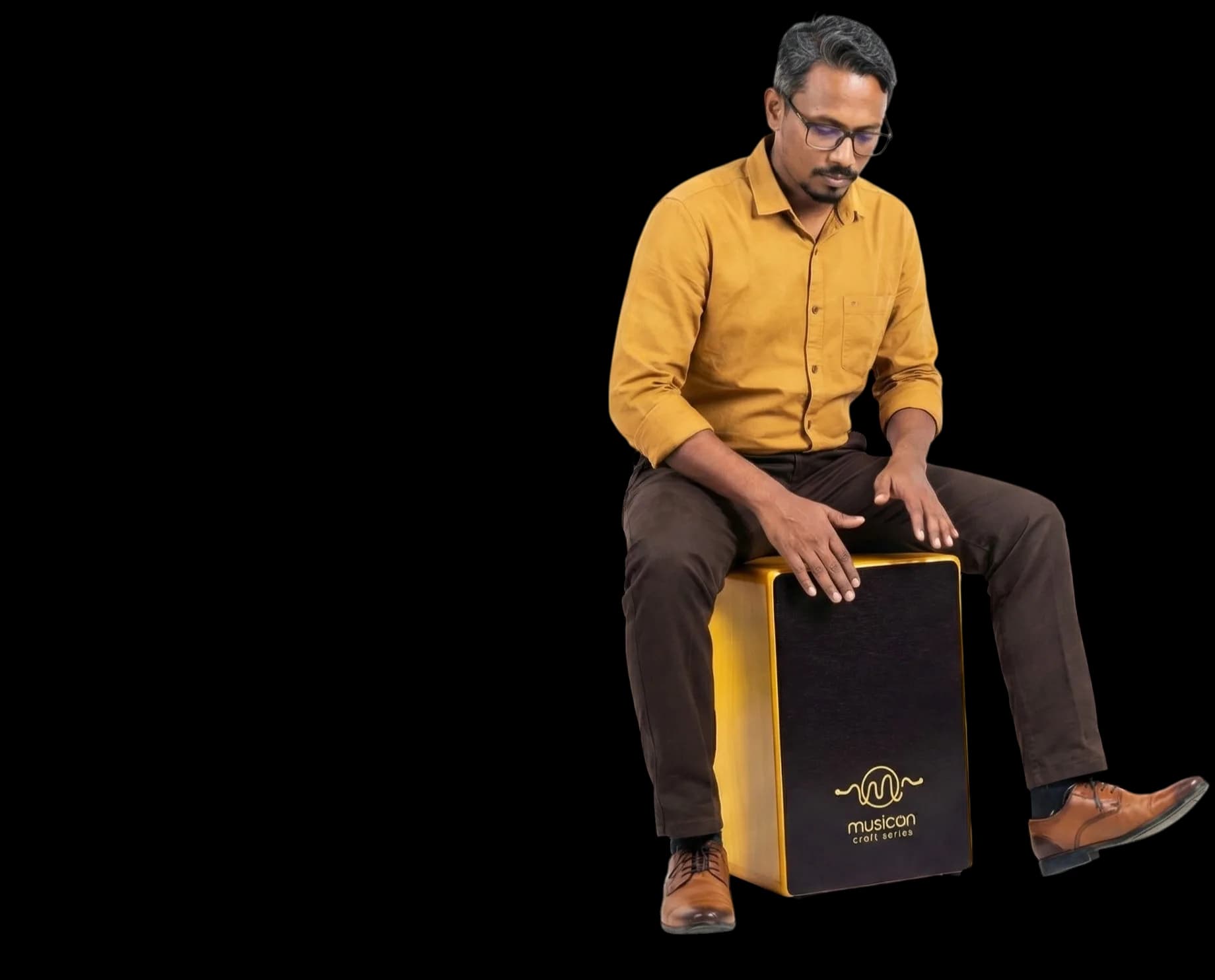 A percussionist playing a MusicOn Craft Series cajon